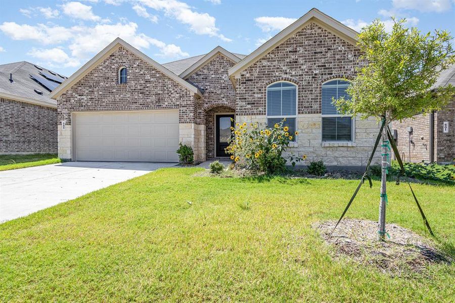 Front exterior of a new home in , Princeton, TX, highlighting curb appeal (Image 1).