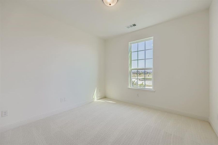 Spare room featuring carpet floors and baseboards