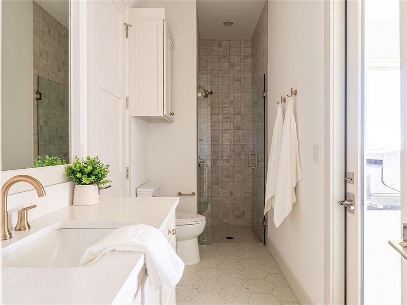 Bathroom with a shower stall and vanity
