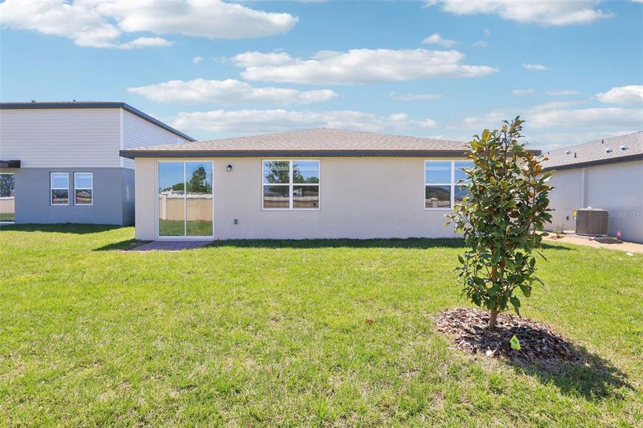 Front exterior of a new home in Lawson Dunes - Signature Series, Haines City, FL, highlighting curb appeal (Image 19). Front exterior of a new home in Lawson Dunes - Signature Series, Haines City, FL, highlighting curb appeal (Image 19).