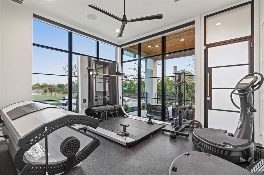 Workout area featuring floor to ceiling windows, ceiling fan, and recessed lighting Workout area featuring floor to ceiling windows, ceiling fan, and recessed lighting