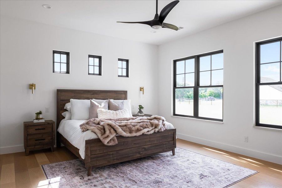 Bedroom featuring multiple windows and wood finished floors