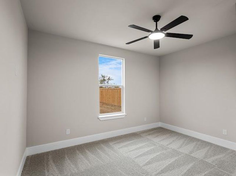 Unfurnished room featuring carpet flooring and ceiling fan