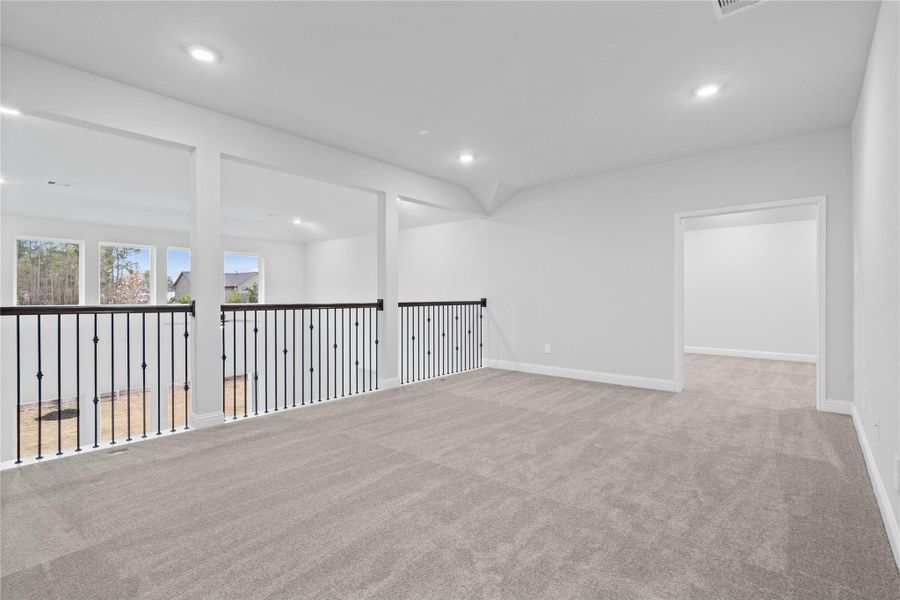 Perfect for entertaining is this amazing Game Room! Right upstairs this space would be a fabulous teen hangout or adult game room complete with enough room for a pool table and big screen TVs! Featuring plush carpet, high ceilings, custom paint and beautiful views of the 1st floor!