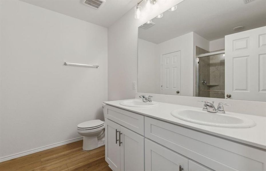 Owner's bathroom with dual vanity *real home pictured