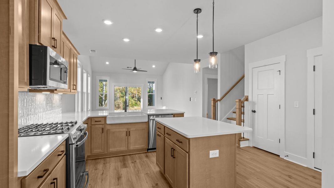 Superior craftsmanship shines in this modern kitchen with a space-saving island and open flow Superior craftsmanship shines in this modern kitchen with a space-saving island and open flow