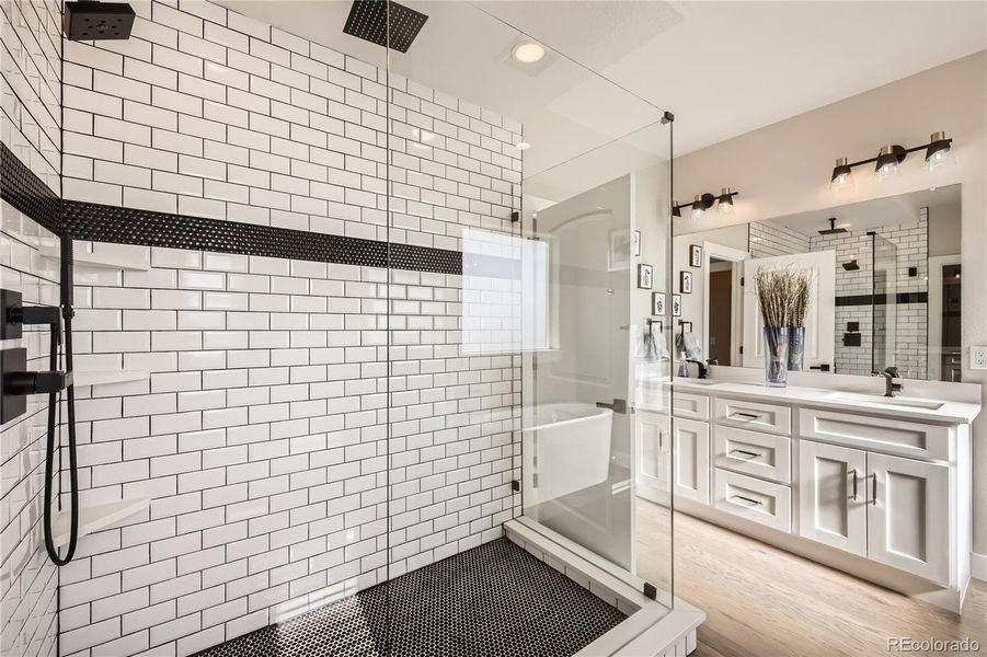 Check out the amazing, custom-designed shower. This bathroom offers an electric fireplace, too! In addition, it has a separate toilet room, and a massive walk-in closet!