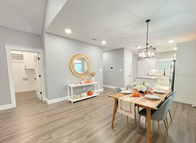 Dining area with light wood-style flooring, recessed lighting, and a chandelier Dining area with light wood-style flooring, recessed lighting, and a chandelier