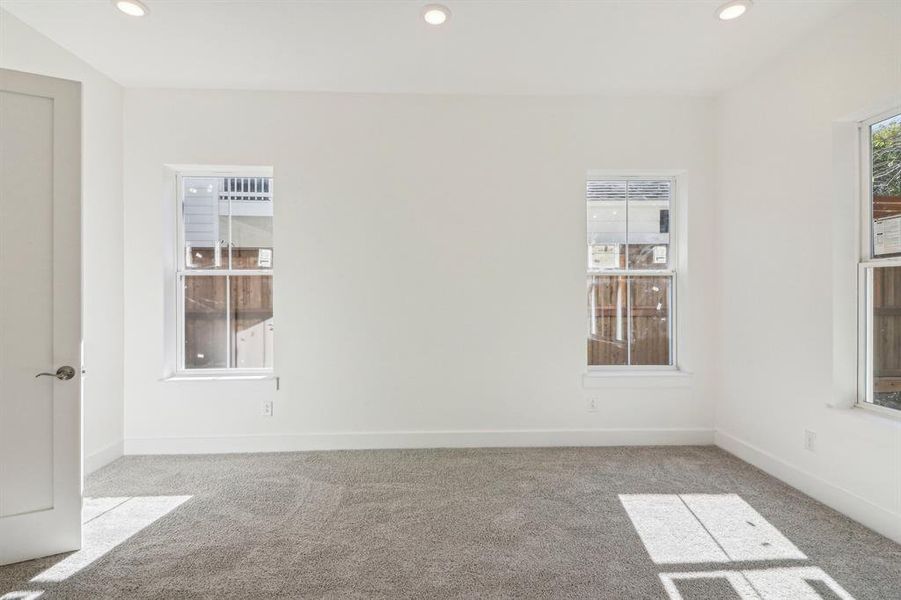 Empty room with recessed lighting and carpet floors