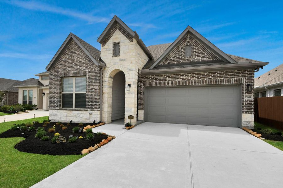 Angle home view of stone and brick like new David Weekley Home with all the upgrades!