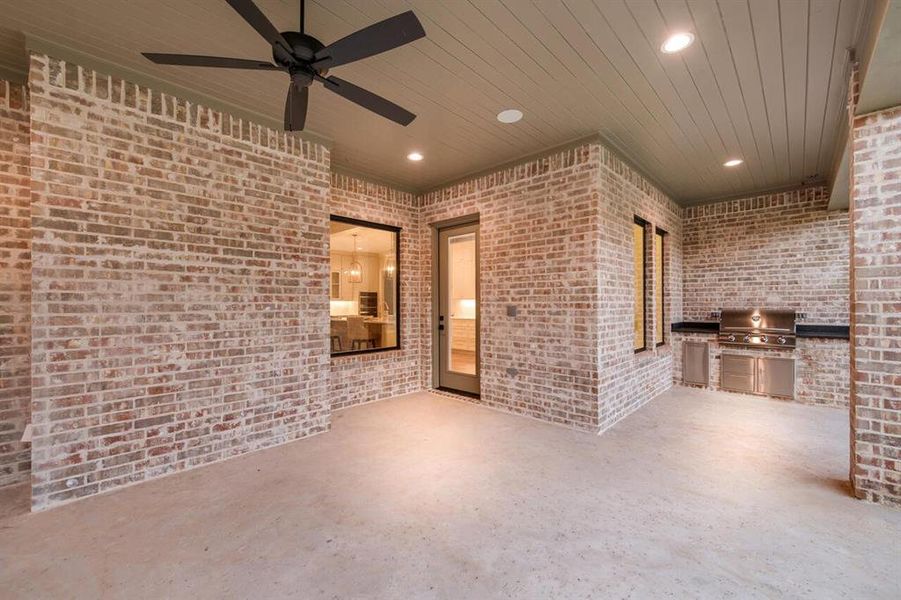 View of patio / terrace with exterior kitchen and a ceiling fan View of patio / terrace with exterior kitchen and a ceiling fan