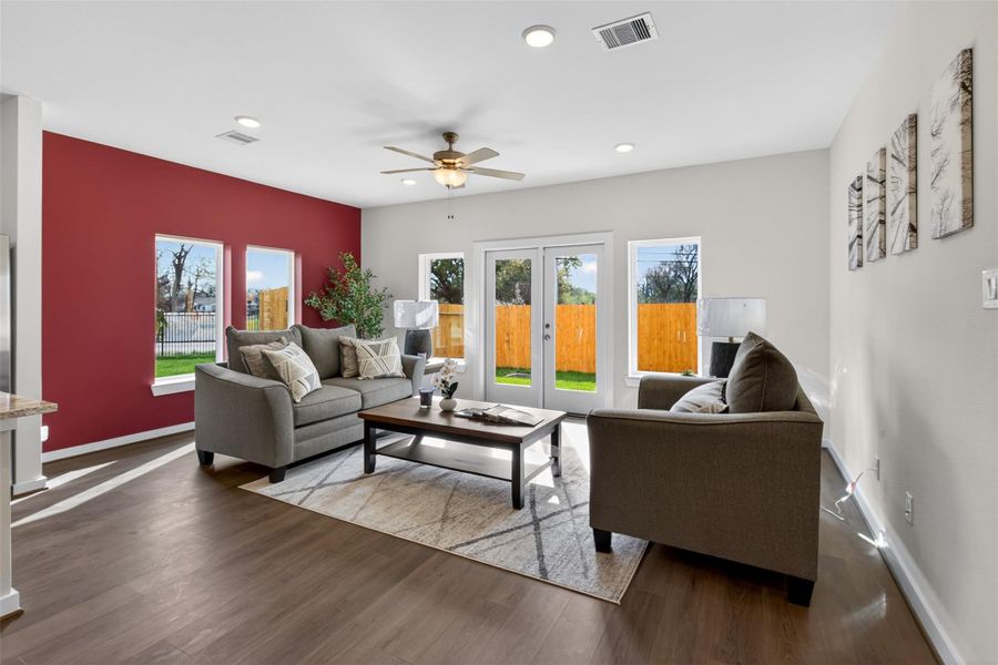 Comfortable living space with abundant light and backyard views, creating a warm and welcoming atmosphere. Comfortable living space with abundant light and backyard views, creating a warm and welcoming atmosphere.