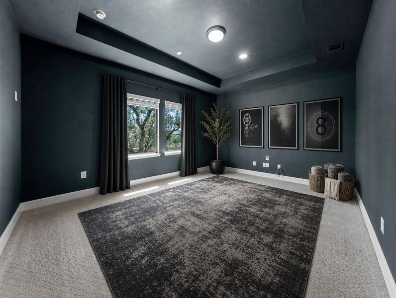 A well-lit room offers versatility for various uses, featuring windows with exterior views and a layered rug over soft carpeting. A well-lit room offers versatility for various uses, featuring windows with exterior views and a layered rug over soft carpeting.