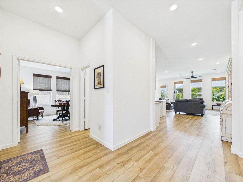 Further down the foyer to the left is the access to the garage, a large office space with glass french doors and a half bath.