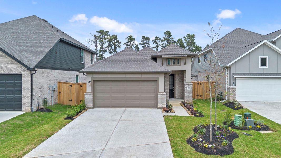 Front exterior of a new home in Grand Central Park, Conroe, TX, highlighting curb appeal (Image 22).