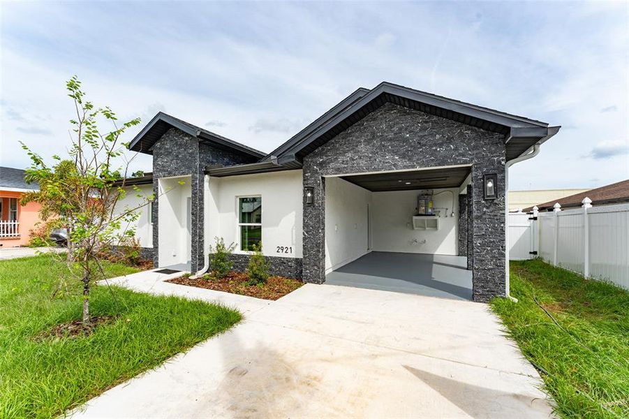 Front exterior of a new home in , Tampa, FL, highlighting curb appeal (Image 1).