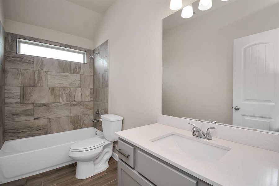 This spacious primary bathroom features a generous vanity with ample counter space, perfect for your morning and evening routines. **This image is from another Saratoga Home with similar floor plan and finishes, not the Brittany floorplan.**