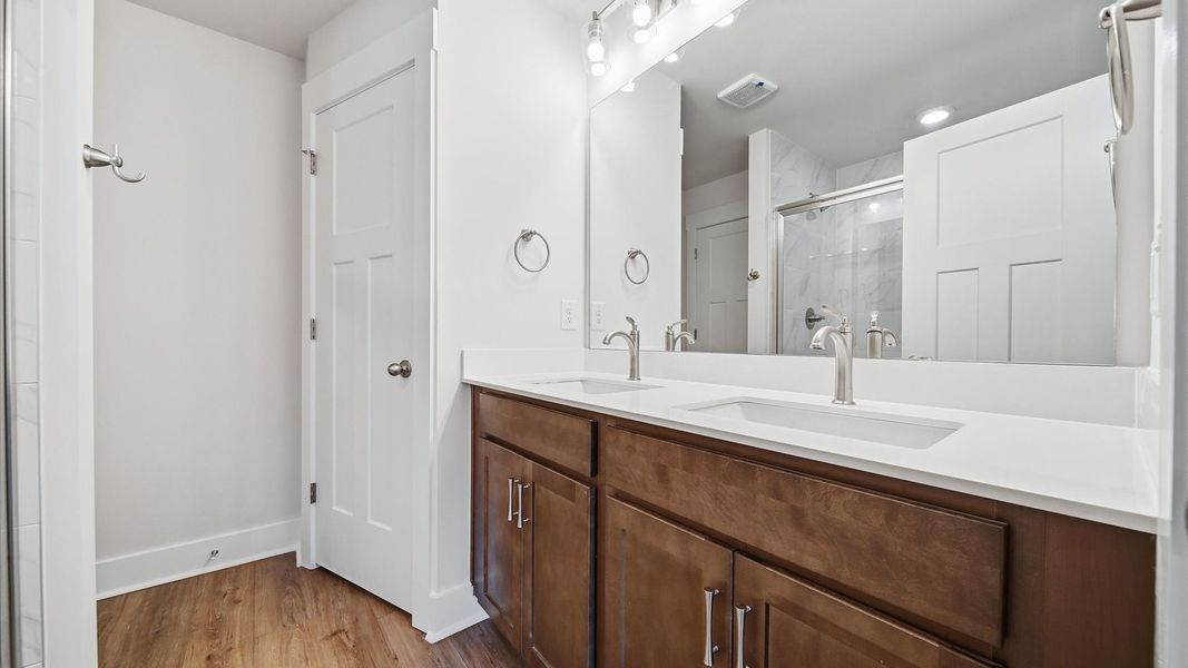 Notable primary suite with dual vanities and walk-in shower in this prime Piedmont villa Notable primary suite with dual vanities and walk-in shower in this prime Piedmont villa
