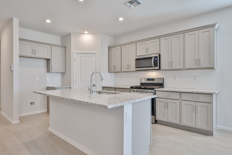 A kitchen with white cabinets. A kitchen with white cabinets.