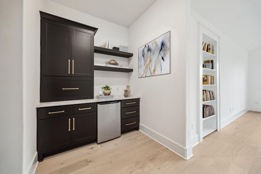 Primary suite foyer includes coffee bar with mini fridge and appliance garage Primary suite foyer includes coffee bar with mini fridge and appliance garage