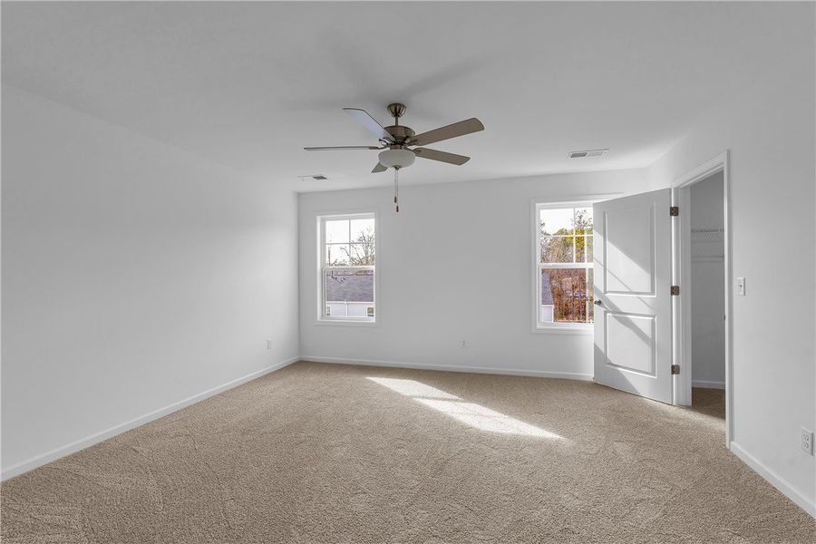 This spacious bedroom offers abundant natural ligh