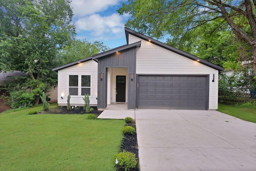 Contemporary exterior featuring white horizontal siding and vertical dark gray accents Contemporary exterior featuring white horizontal siding and vertical dark gray accents
