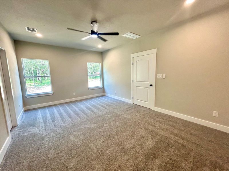 Primary bedroom with view of the backyard.