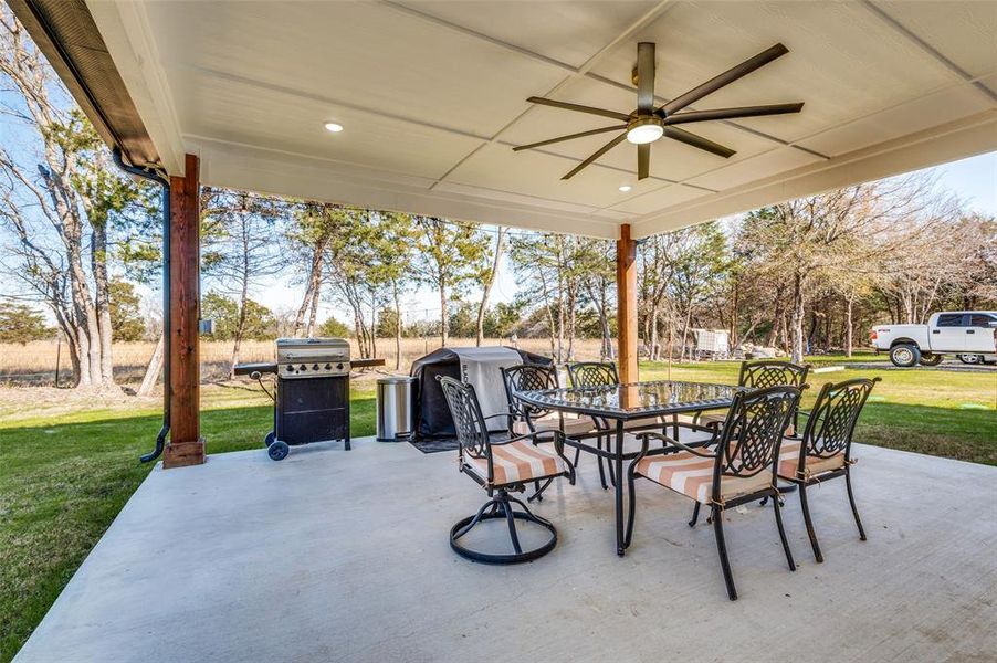 View of patio with a ceiling fan, a grill, and outdoor dining space