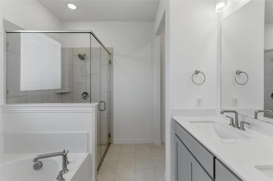 Contemporary bathroom featuring a dual vanity with rectangular undermount sinks, brushed nickel faucets, and a large mirror
