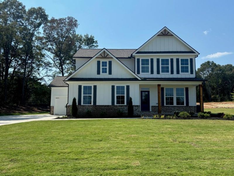 Front exterior of a new home in Pinegate, Covington, GA, highlighting curb appeal (Image 24). Front exterior of a new home in Pinegate, Covington, GA, highlighting curb appeal (Image 24).