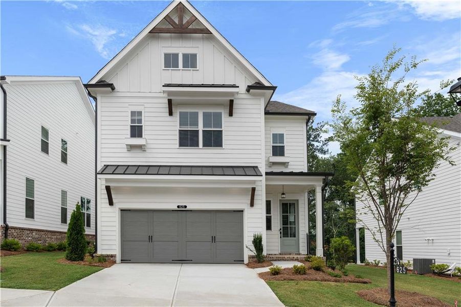 Front exterior of a new home in Palisades Single Family, Cumming, GA, highlighting curb appeal (Image 1).