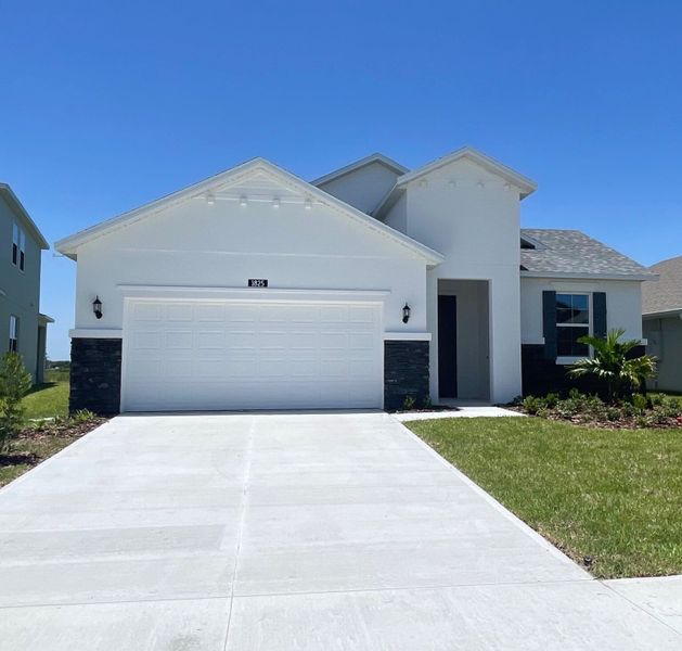 Front exterior of a new home in St. Johns Preserve, Palm Bay, FL, highlighting curb appeal (Image 1). Front exterior of a new home in St. Johns Preserve, Palm Bay, FL, highlighting curb appeal (Image 1).