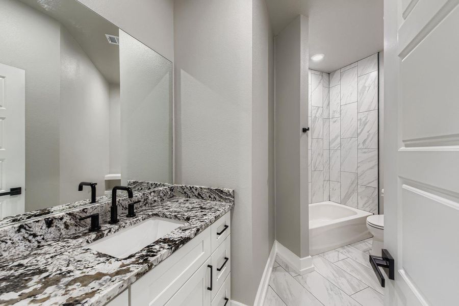 Full bathroom with vanity, bathtub / shower combination, and light marble finish floors