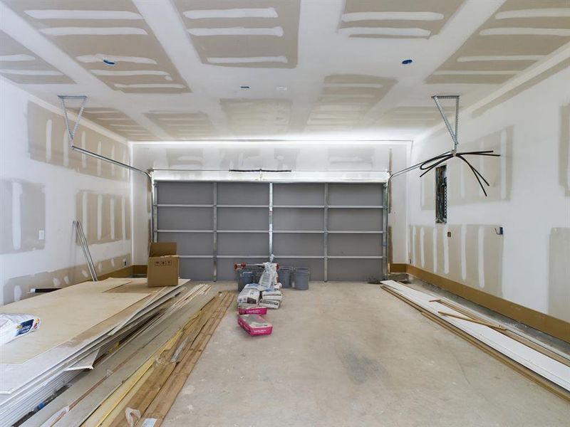 Spacious garage with built-in EV charging station.