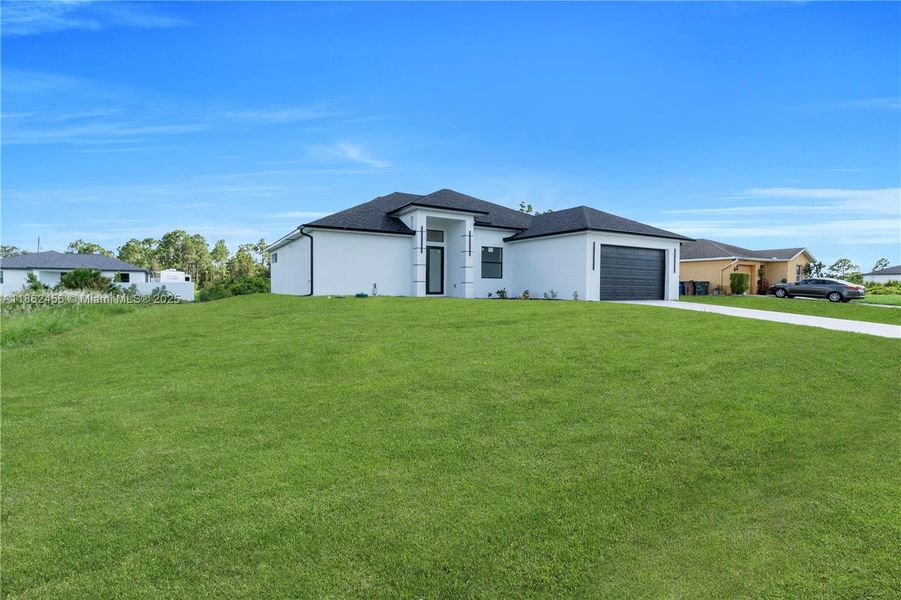 Front exterior of a new home in , Lehigh Acres, FL, highlighting curb appeal (Image 21). Front exterior of a new home in , Lehigh Acres, FL, highlighting curb appeal (Image 21).