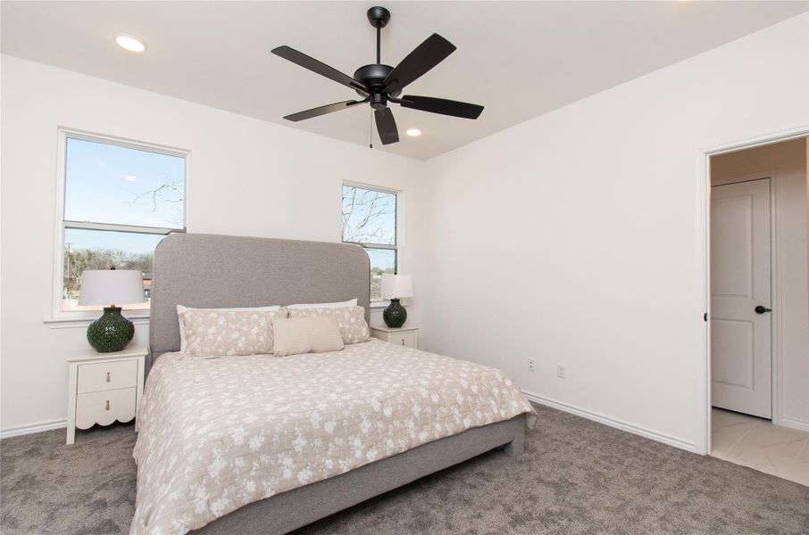 Bedroom with carpet floors, ceiling fan, and recessed lighting