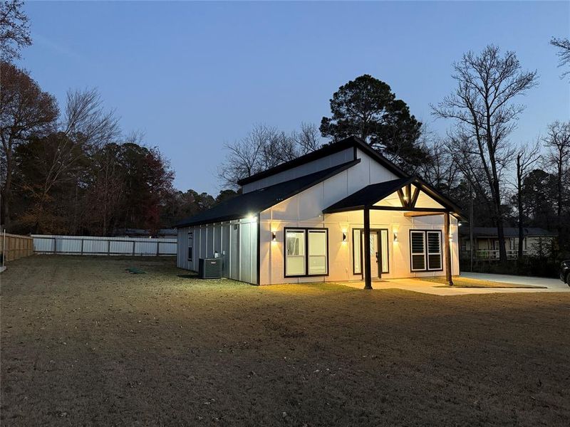 Rear view of house with a fenced backyard