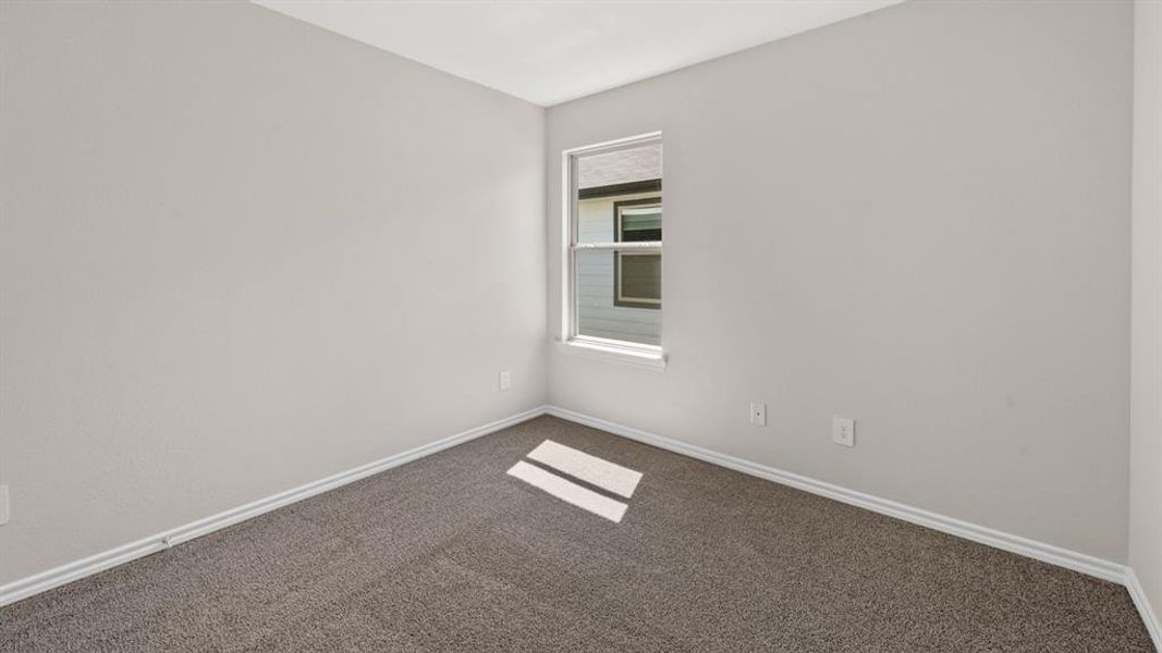 Neutral-toned interior room featuring light gray walls, white trim, and gray carpet
