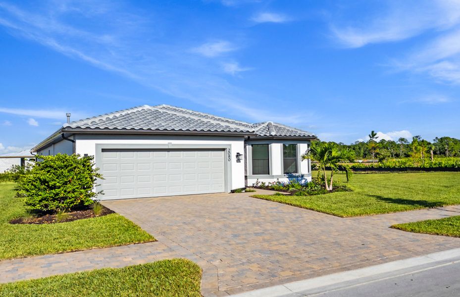 Front exterior of a new home in Terreno, Naples, FL, highlighting curb appeal (Image 1).