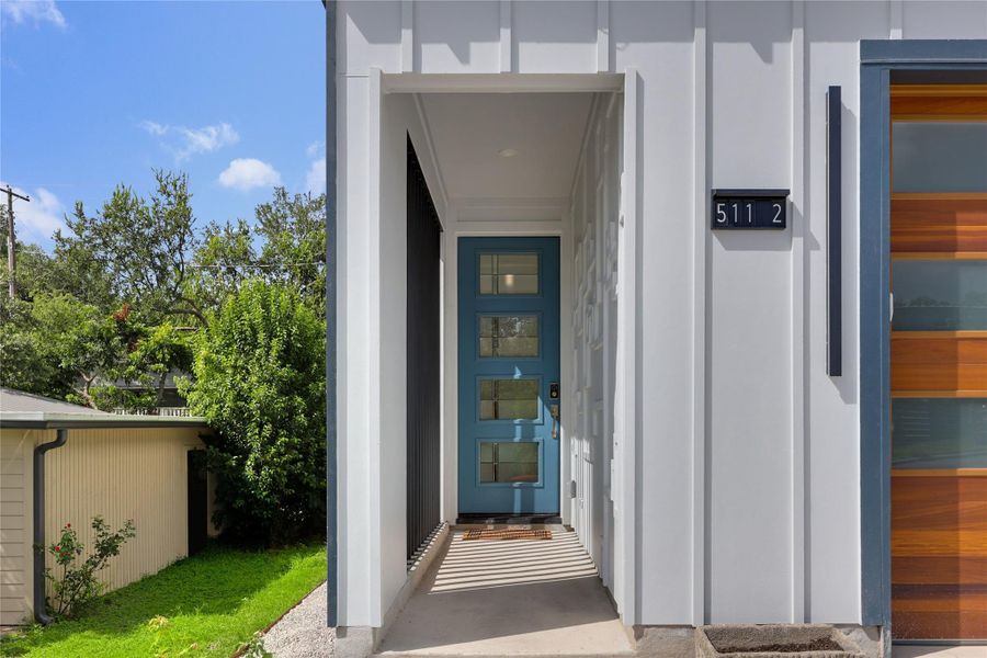 Board and Batten siding, a custom metal privacy screen and wood accent wall in the entry way. Board and Batten siding, a custom metal privacy screen and wood accent wall in the entry way.