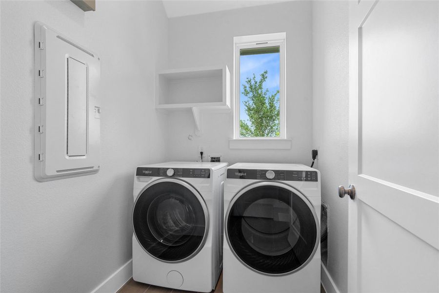 This dedicated laundry room comes equipped with a washer and dryer set, ready for immediate use.