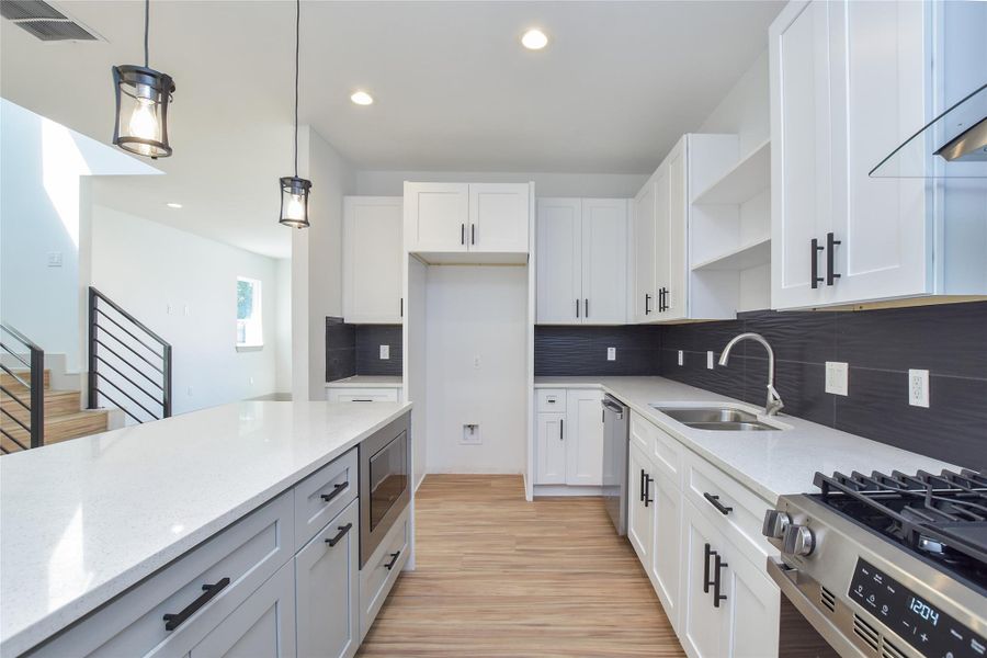 Great kitchen! Lots of countertop space & storage. SS appliances. Slide-in gas range, dishwasher & built-in microwave. Modern vent hood. Refrigerator is preplumbed for ice maker connection. Large island with space for several barstools.