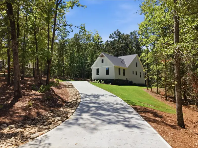 A long concrete driveway sweeps up toward the mode
