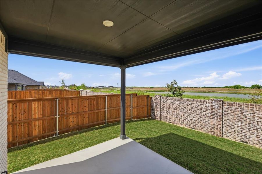 Fenced backyard with a patio area Fenced backyard with a patio area