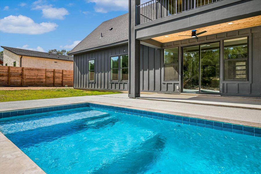 An inviting backyard oasis offers a sparkling in-ground pool, perfect for outdoor living.