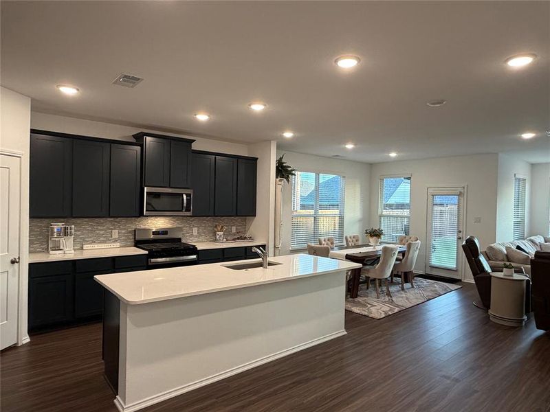 Kitchen Features Striking 42” Adriatic Sea Cabinets Complete with a Gas Range and Walk-In Pantry. Spacious Breakfast Area and Island Bar Seating Works Great, If You Choose to Use Dining as Home Office.