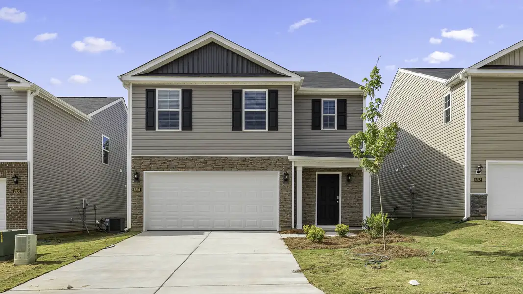 Front exterior of a new home in Fishel Village, Winston-Salem, NC, highlighting curb appeal (Image 1). Front exterior of a new home in Fishel Village, Winston-Salem, NC, highlighting curb appeal (Image 1).