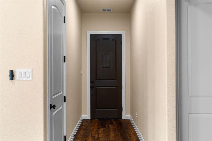 Hallway with dark wood-type flooring