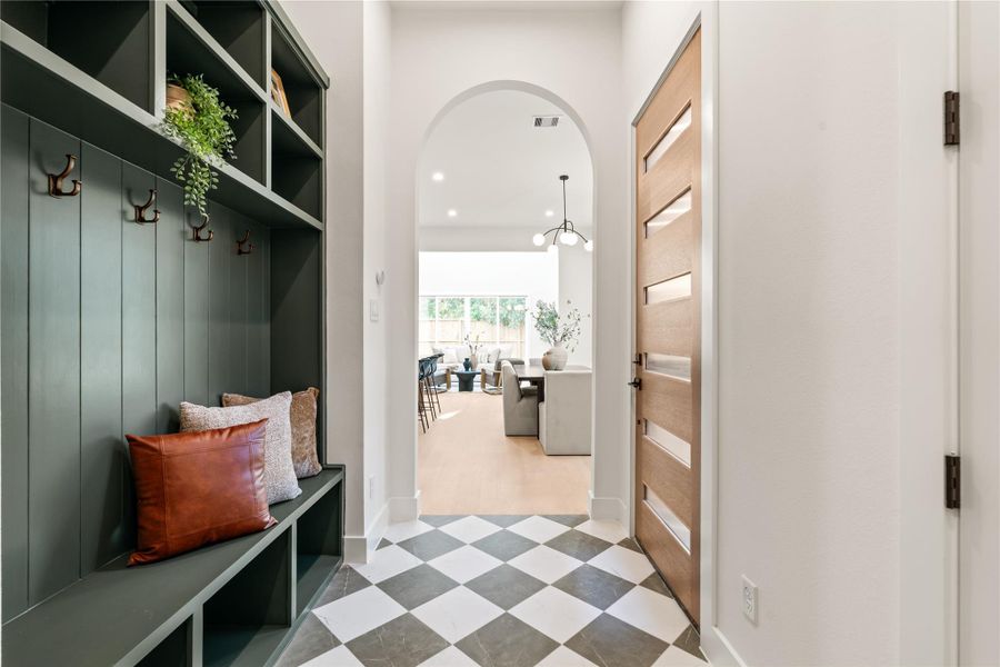 As you enter your foyer, a large mud bench with beautifully appointed checkered tiles and elegant archway welcomes you home. As you enter your foyer, a large mud bench with beautifully appointed checkered tiles and elegant archway welcomes you home.