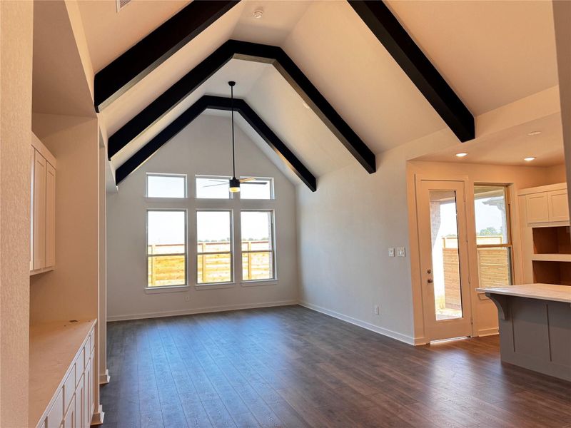 Wood beams add warmth and texture to this expansive open-concept space. Wood beams add warmth and texture to this expansive open-concept space.